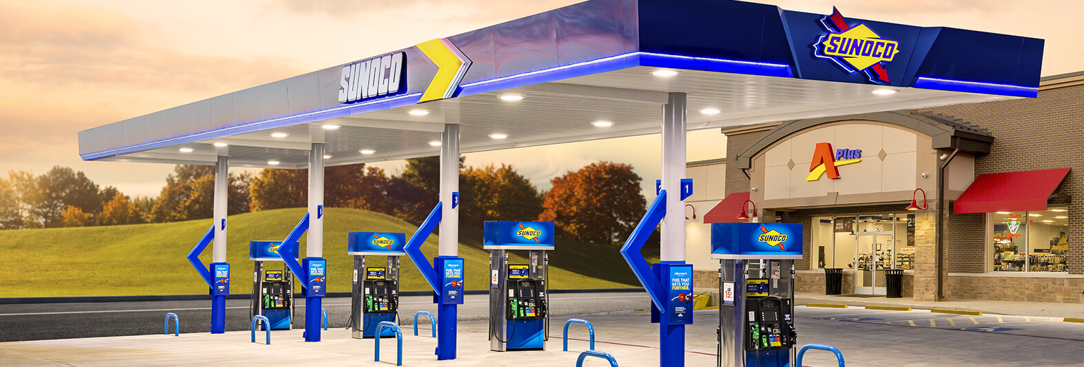 Aplus store with Sunoco branded fuel pumps at sunset