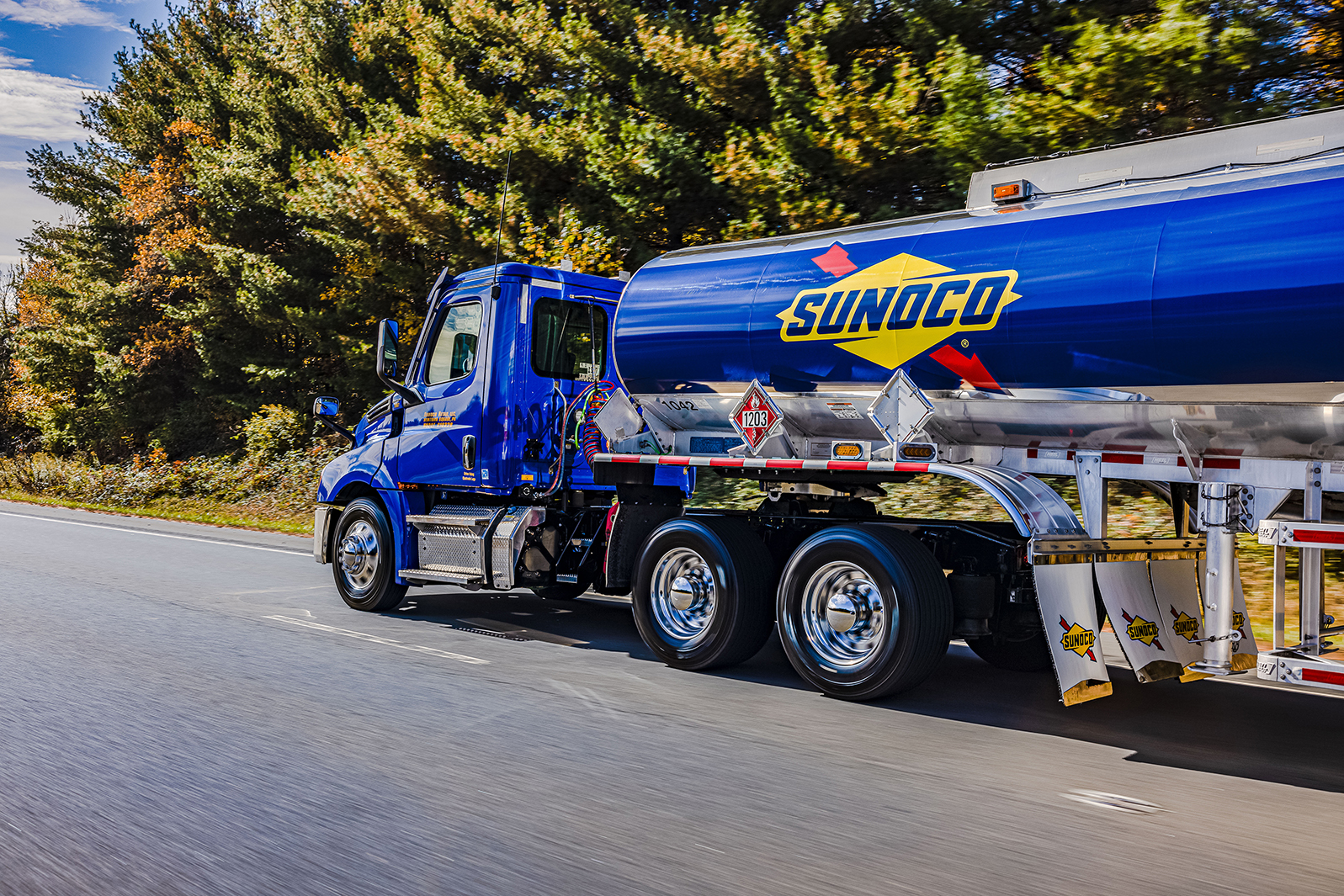 Sunoco fuel delivery truck driving on a highway, showcasing efficient bulk fuel delivery service.