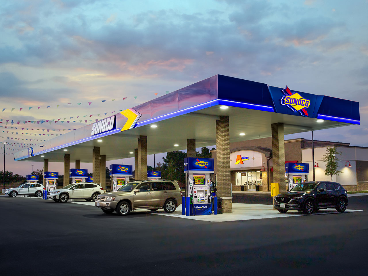 Sunoco gas station with cars refueling, showing benefits of branded fuel distributors for gas station loyalty.