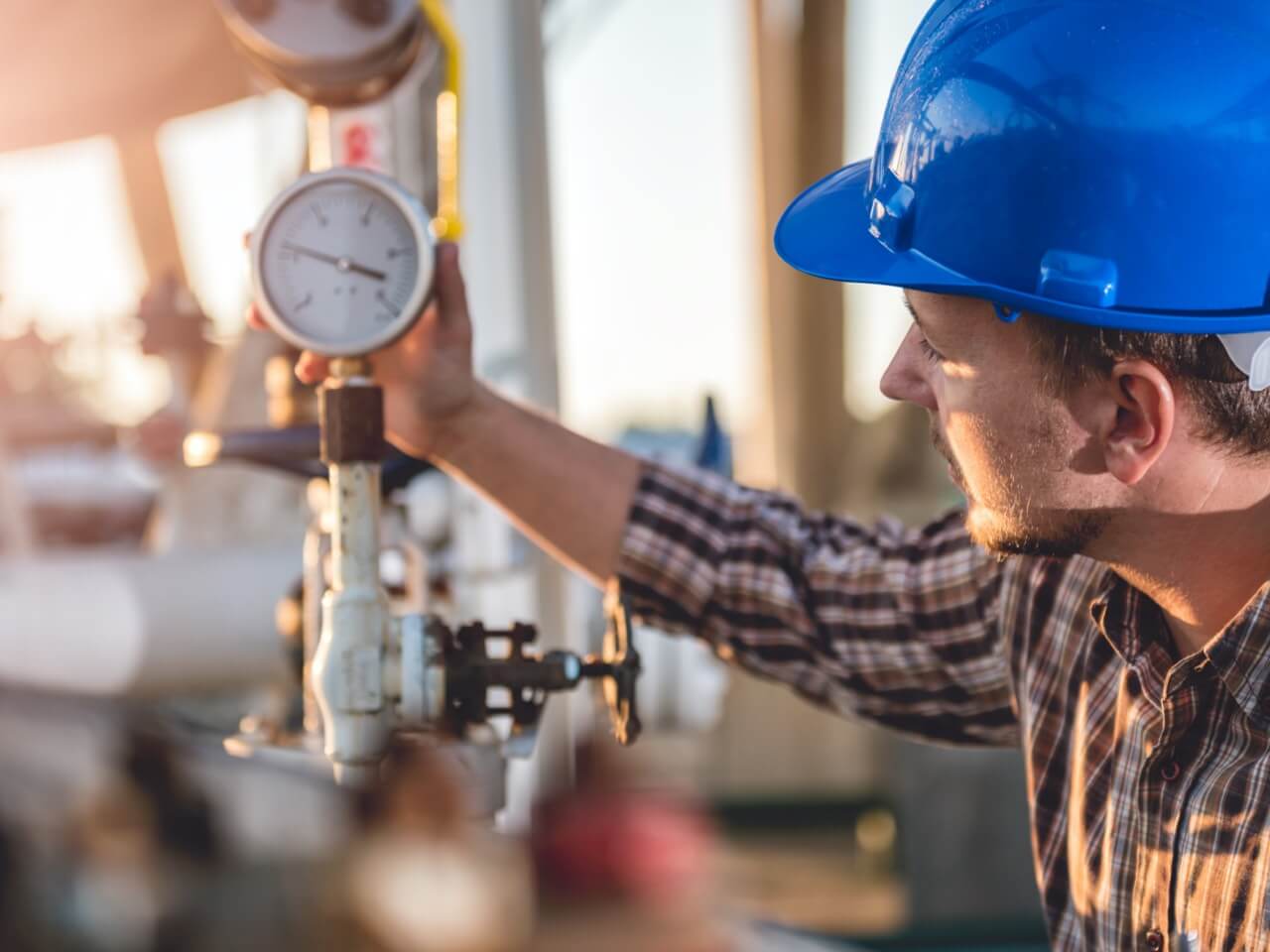 Man checking gauge on unbranded fuel tank